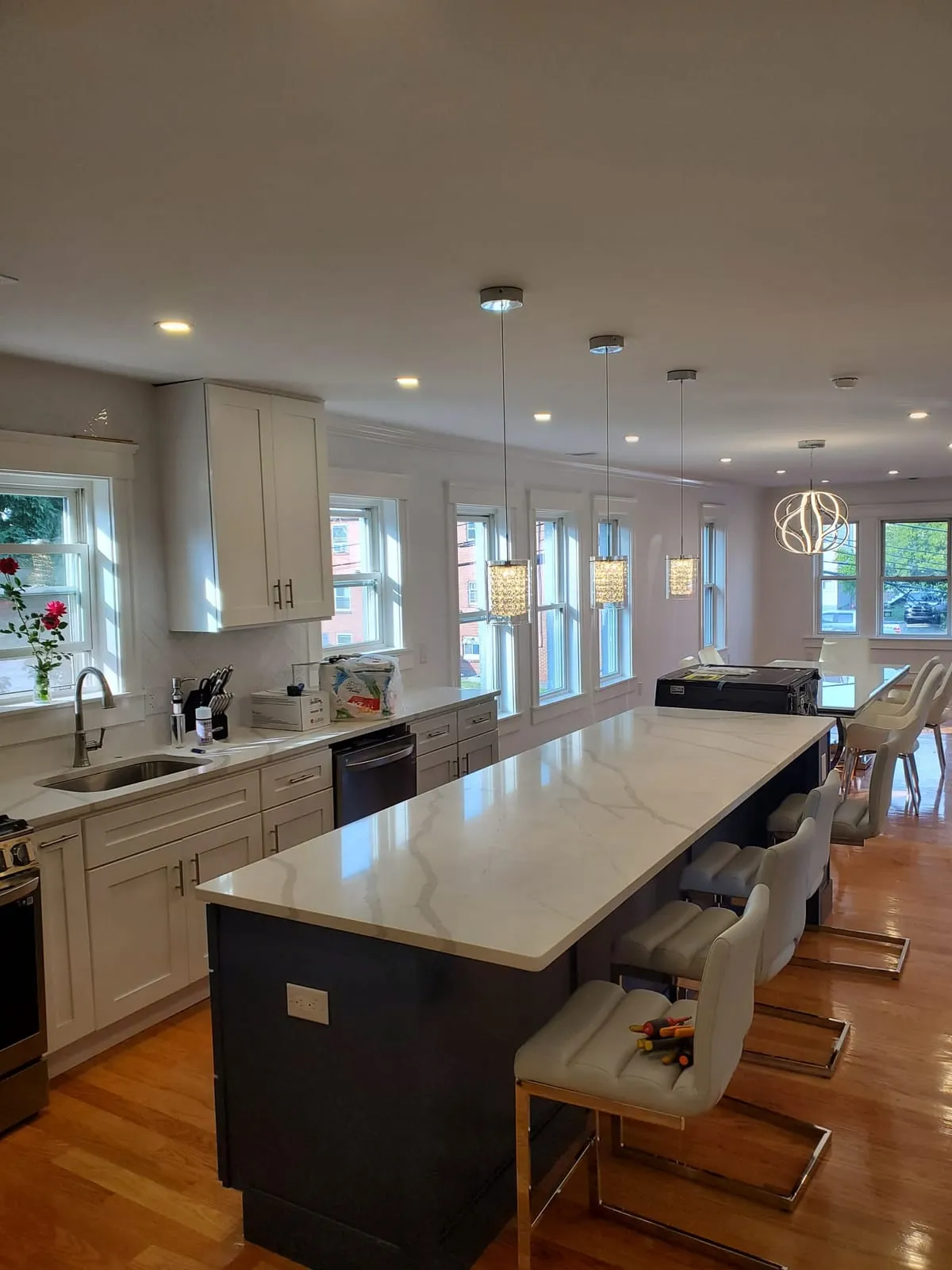 Pendants over a long kitchen island, a Storm Electrical job in Massachusetts