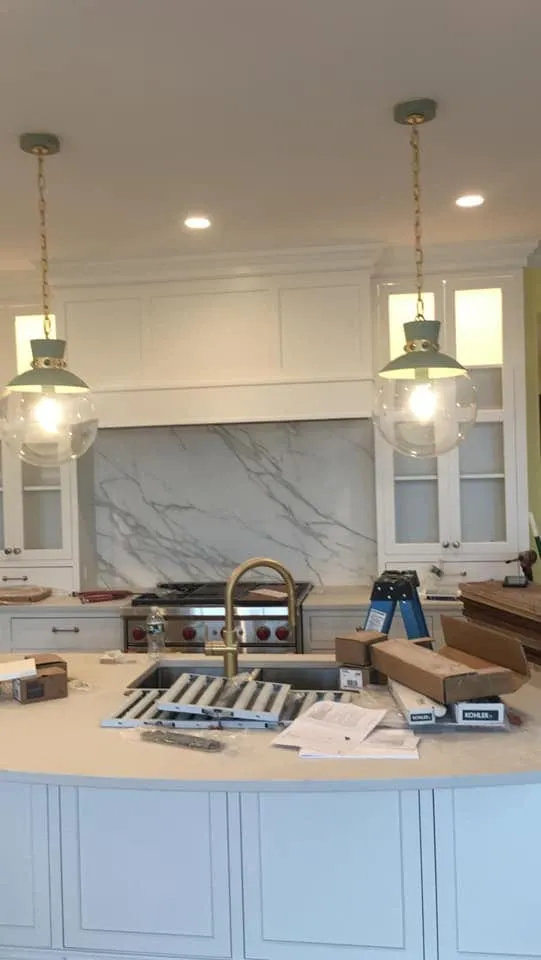Pendants over a marble kitchen island, a Storm Electrical job in Massachusetts
