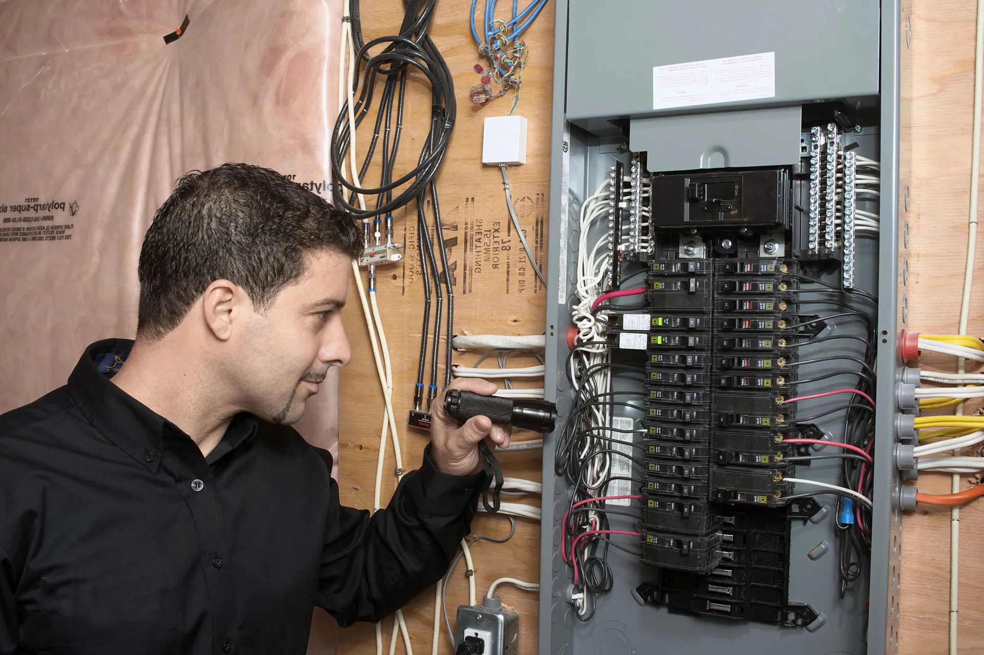 Electrician working on a breaker panel