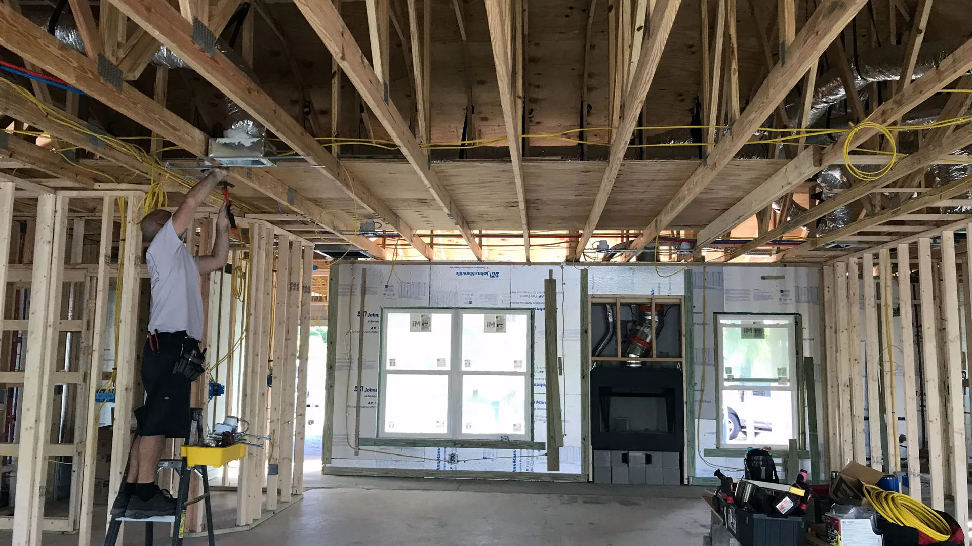 Electrician wiring a new-construction home